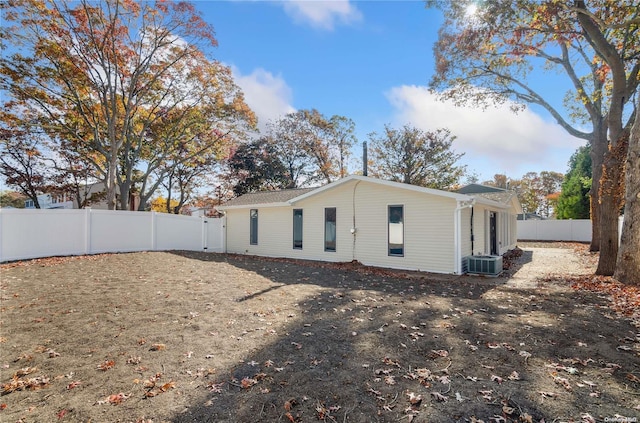 back of house with central AC unit