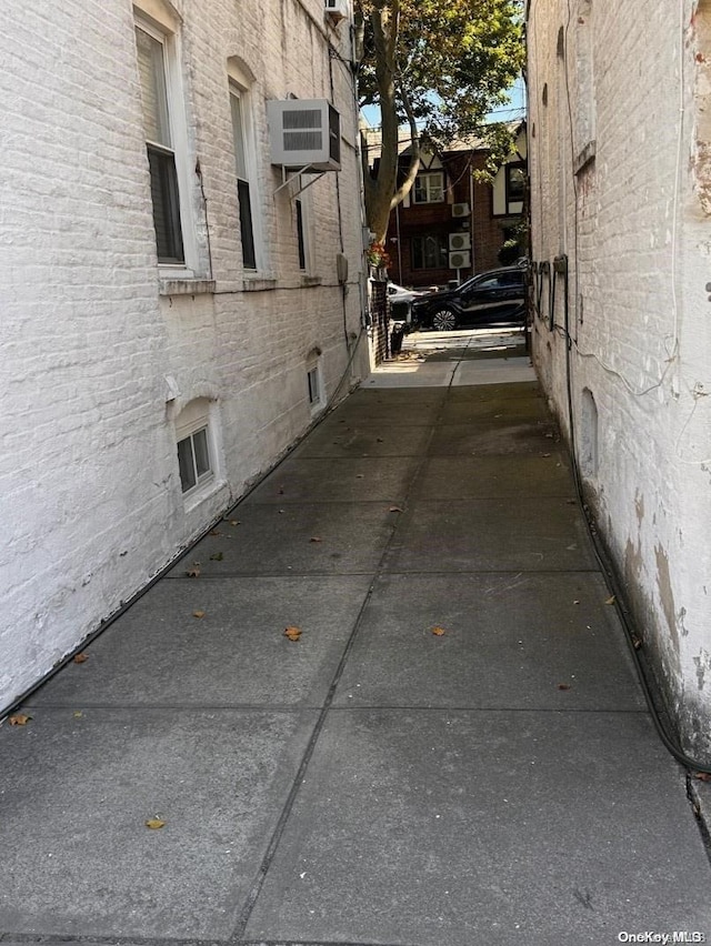 view of side of property with a wall mounted AC