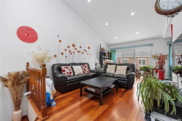 living room with hardwood / wood-style flooring and vaulted ceiling