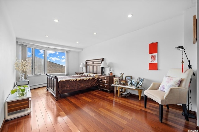 bedroom with a baseboard radiator and wood-type flooring