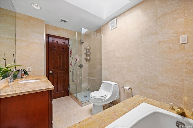 full bathroom with tile patterned floors, toilet, vanity, independent shower and bath, and tile walls