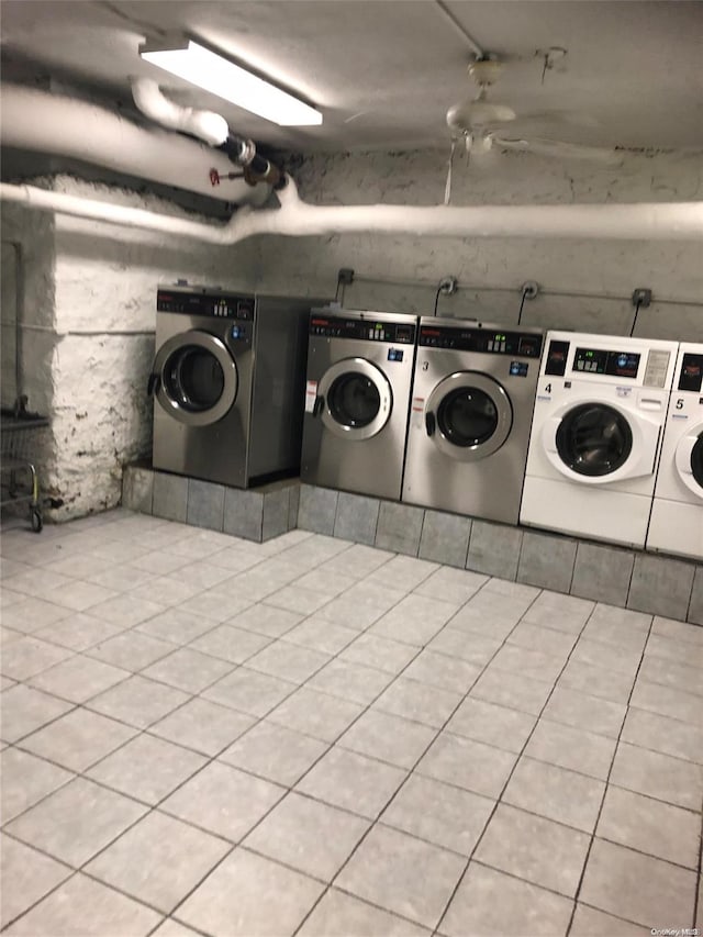 laundry room featuring light tile patterned floors and washing machine and clothes dryer