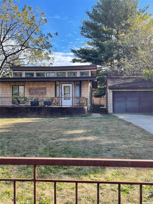 view of front facade with a garage, an outdoor structure, and a front yard