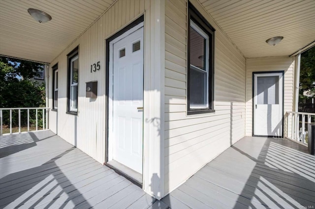 view of exterior entry with a porch