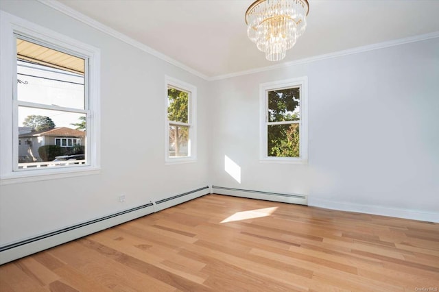 empty room with baseboard heating, ornamental molding, an inviting chandelier, and light hardwood / wood-style floors