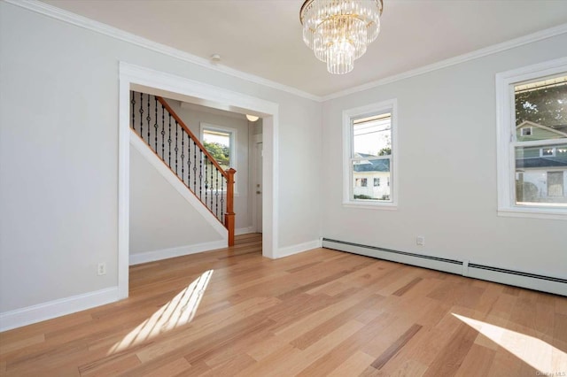 empty room with crown molding, a baseboard radiator, a notable chandelier, and light wood-type flooring