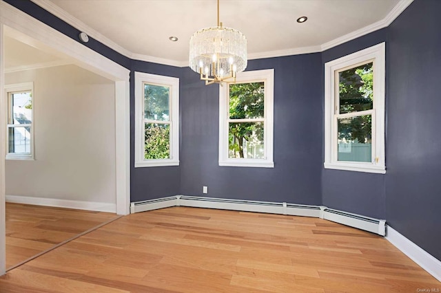 unfurnished room with hardwood / wood-style floors, plenty of natural light, and ornamental molding