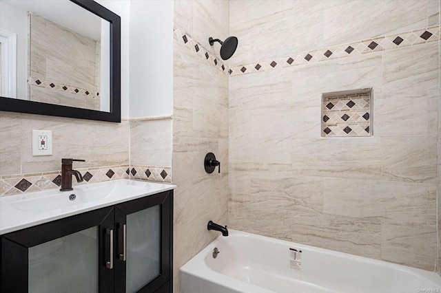 bathroom featuring tiled shower / bath combo, vanity, tile walls, and decorative backsplash