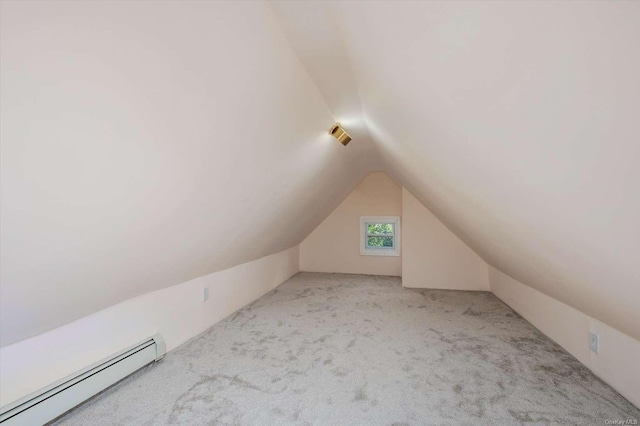 bonus room with a baseboard radiator, vaulted ceiling, and light carpet