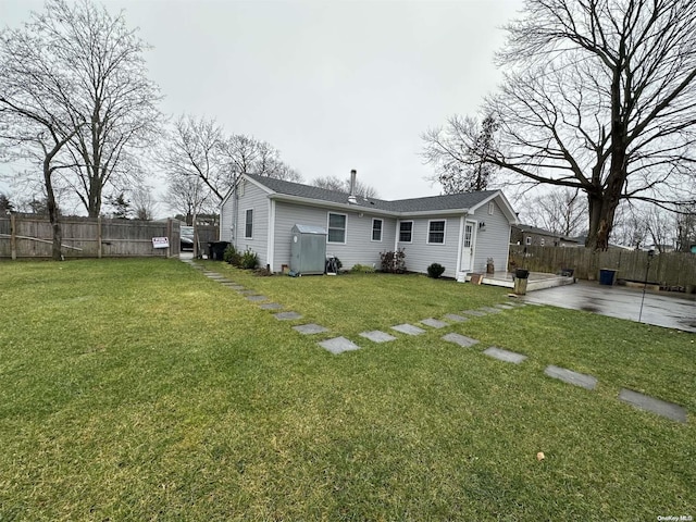 back of property featuring a yard and a patio