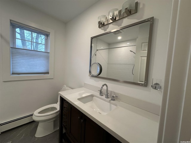 bathroom featuring a tile shower, vanity, toilet, and baseboard heating