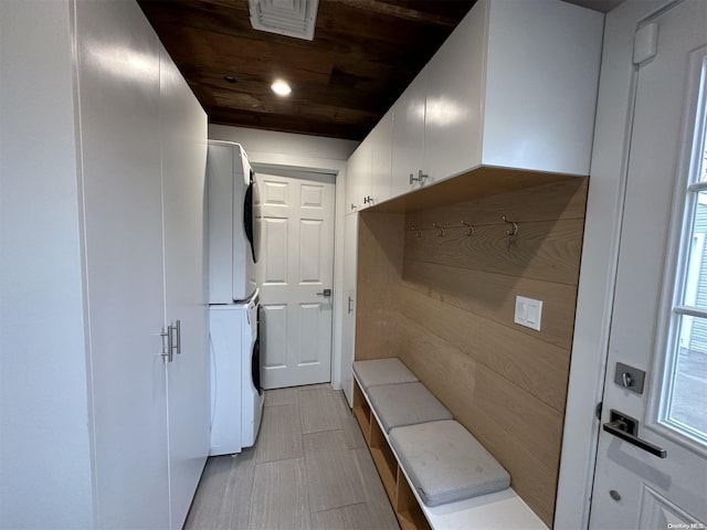 mudroom featuring wooden ceiling and stacked washer / drying machine