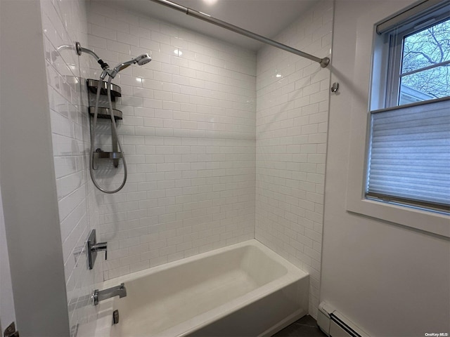 bathroom with tiled shower / bath combo and a baseboard heating unit