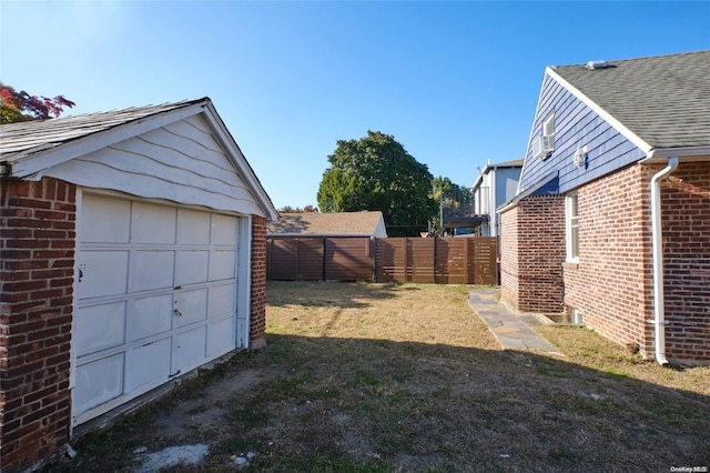 view of yard featuring an outbuilding and a garage