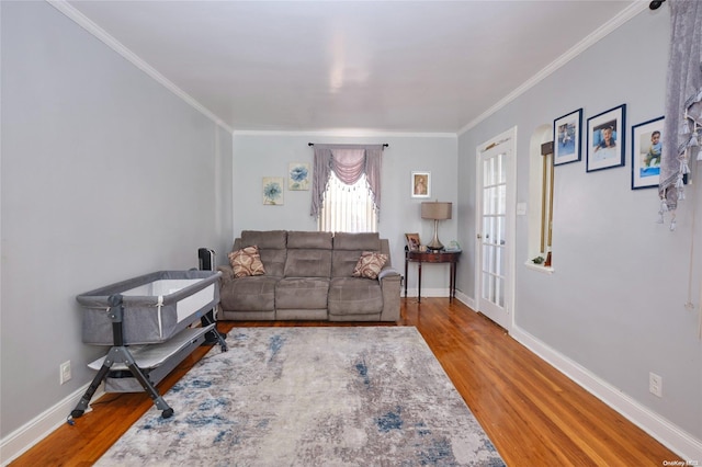 living room featuring wood-type flooring and ornamental molding