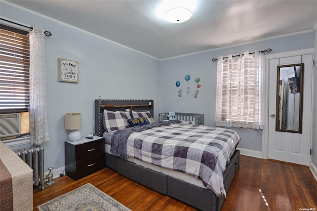 bedroom featuring dark hardwood / wood-style floors, crown molding, and radiator