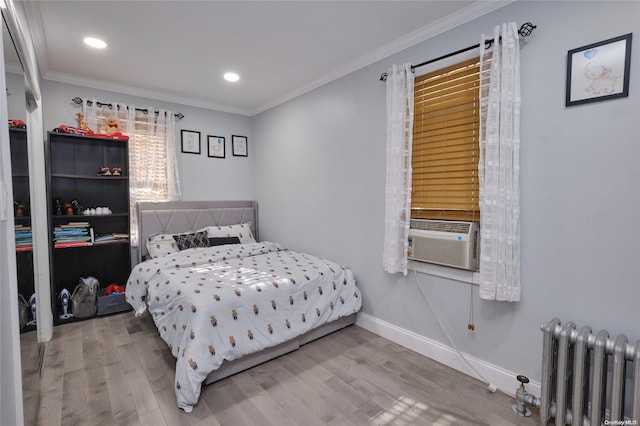 bedroom featuring hardwood / wood-style flooring, cooling unit, radiator heating unit, and ornamental molding