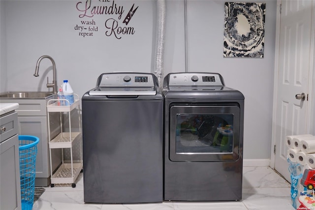 laundry room with cabinets and washing machine and clothes dryer