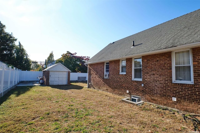 view of yard featuring a garage and an outdoor structure