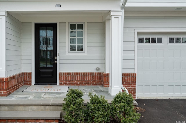 view of exterior entry with covered porch