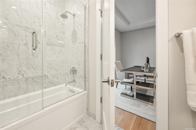 bathroom with shower / bath combination with glass door and hardwood / wood-style floors