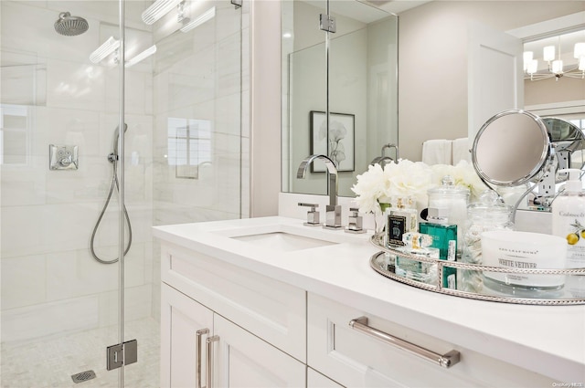 bathroom featuring vanity, an enclosed shower, and a chandelier