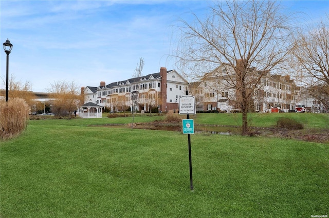 exterior space featuring a front yard and a gazebo