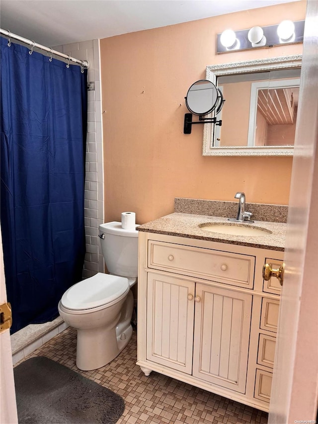 bathroom featuring a shower with curtain, vanity, toilet, and tile patterned flooring