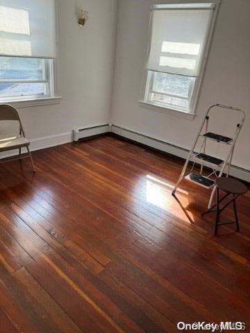 unfurnished room featuring dark hardwood / wood-style flooring