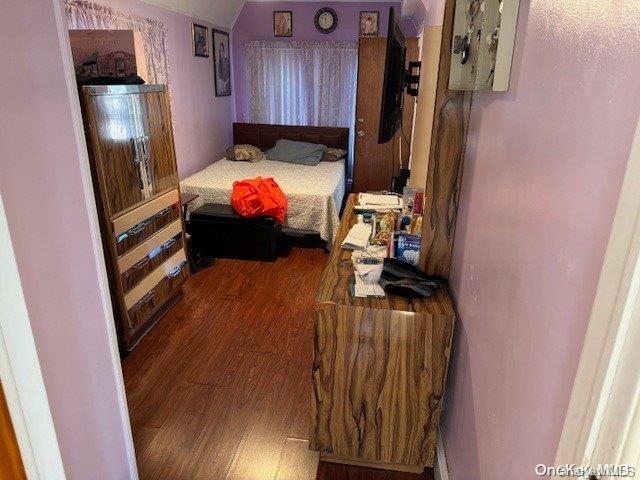 bedroom featuring dark wood-type flooring