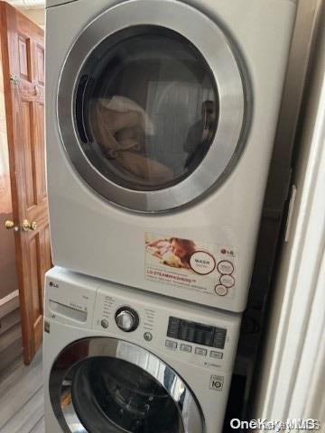 laundry area with stacked washer and clothes dryer