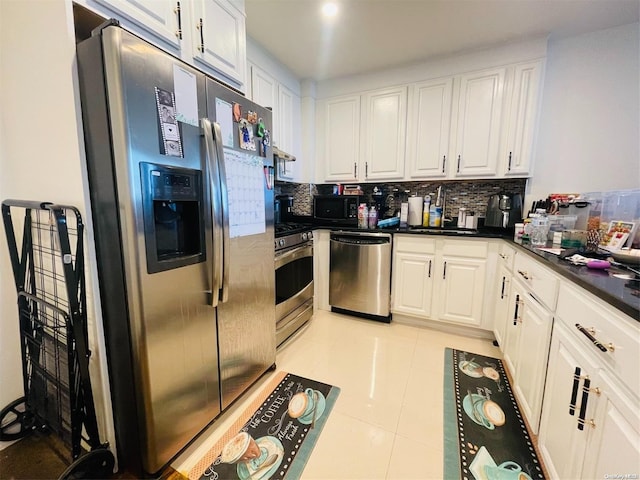 kitchen with white cabinets, sink, decorative backsplash, light tile patterned floors, and stainless steel appliances