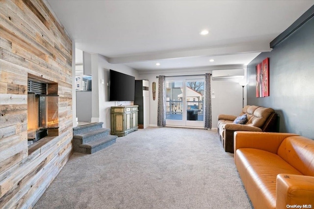 carpeted living room with a wall unit AC and beamed ceiling