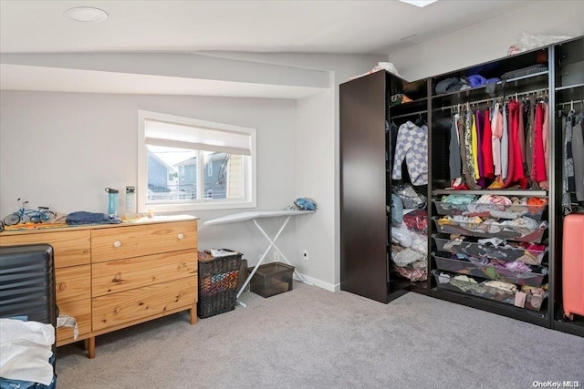 carpeted bedroom featuring a closet and lofted ceiling