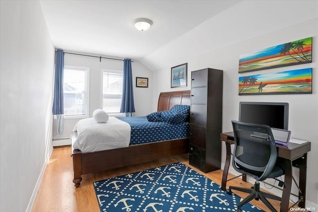 bedroom featuring wood-type flooring, a baseboard radiator, and vaulted ceiling