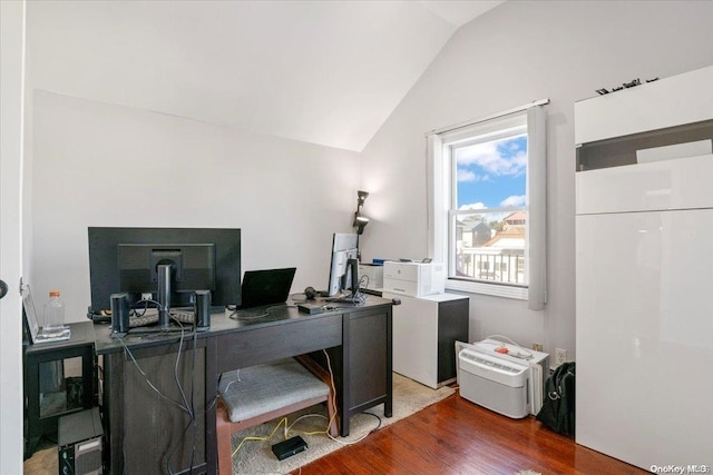 office space with dark hardwood / wood-style floors and vaulted ceiling