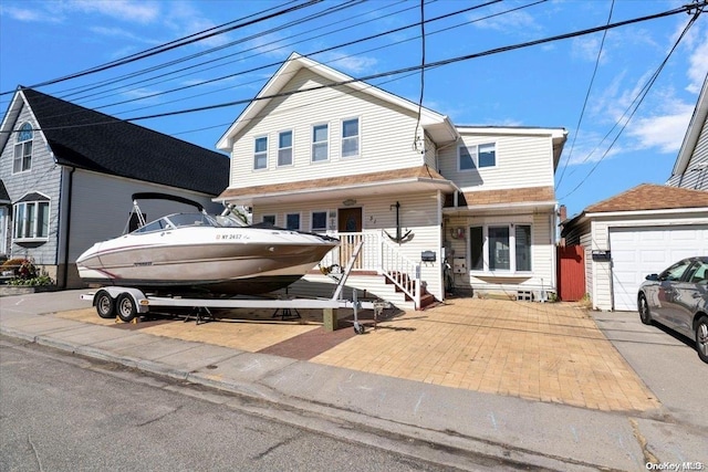 view of property with an outbuilding and a garage