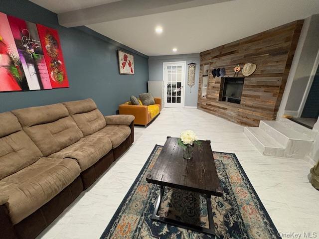 living room featuring beam ceiling and crown molding