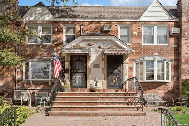 townhome / multi-family property with a wall unit AC