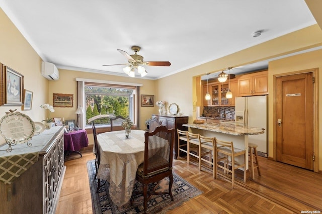 dining room with dark parquet floors, ceiling fan, an AC wall unit, and ornamental molding