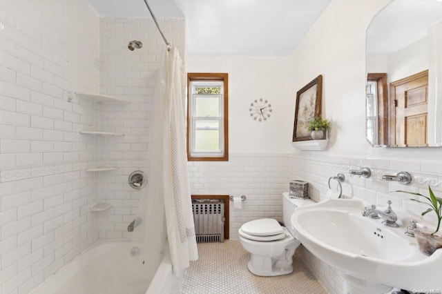 bathroom with radiator, shower / bathtub combination with curtain, tile patterned flooring, toilet, and tile walls