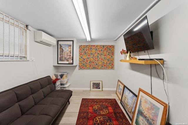 living room featuring light hardwood / wood-style floors and an AC wall unit