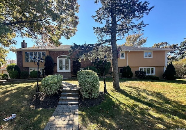 split foyer home with french doors and a front lawn