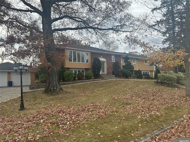 view of front of property with a garage and a front lawn