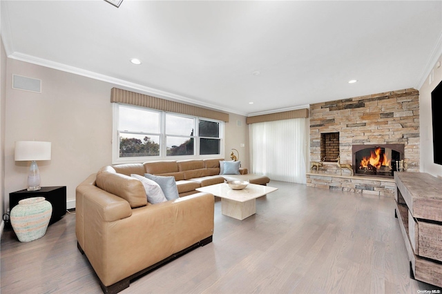 living room featuring a fireplace, light hardwood / wood-style floors, and crown molding