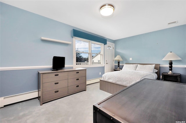 bedroom featuring baseboard heating and light carpet