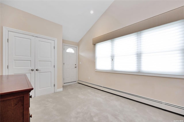 entryway with light carpet, a baseboard radiator, and vaulted ceiling