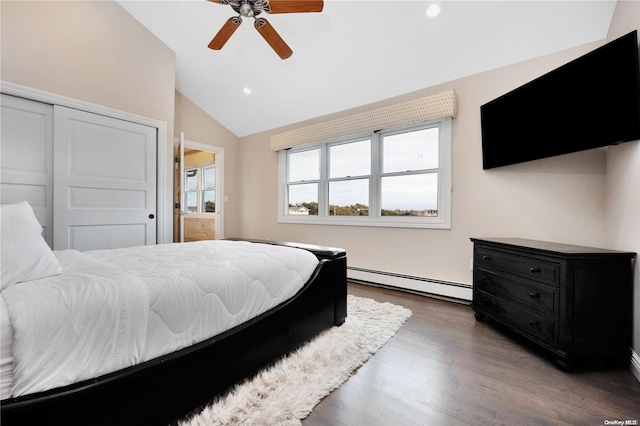 bedroom featuring ceiling fan, dark wood-type flooring, a baseboard heating unit, vaulted ceiling, and a closet