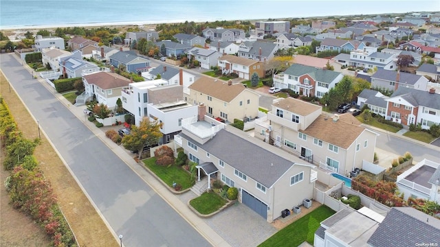 bird's eye view featuring a water view and a beach view