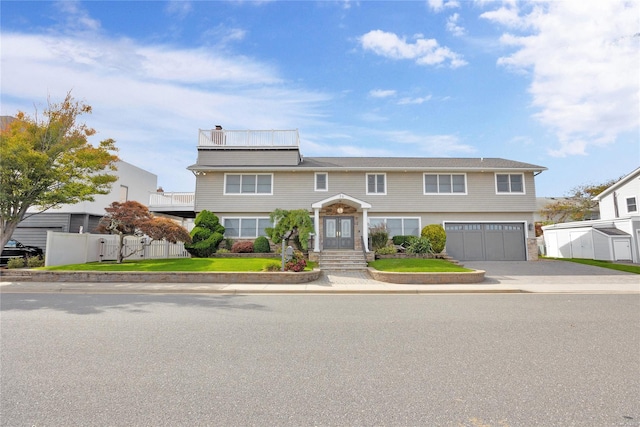 view of front of home with a garage and a front lawn